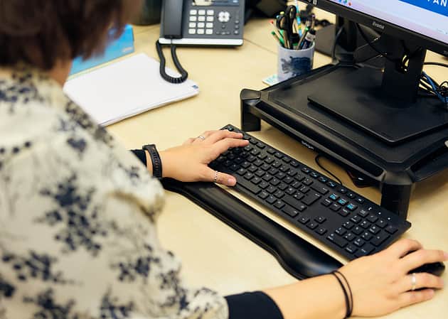 A woman working at a computer.