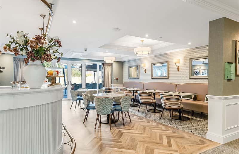 A modern, elegantly designed interior with light tones, cozy seating, and a welcoming atmosphere.