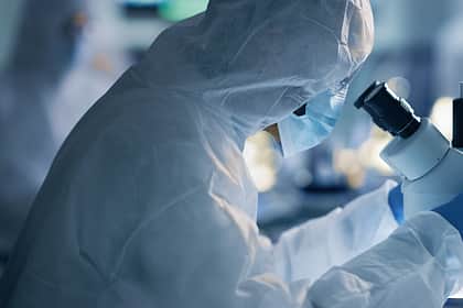 Suited Lab Staring into microscope