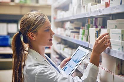 Woman selecting medication from shelf