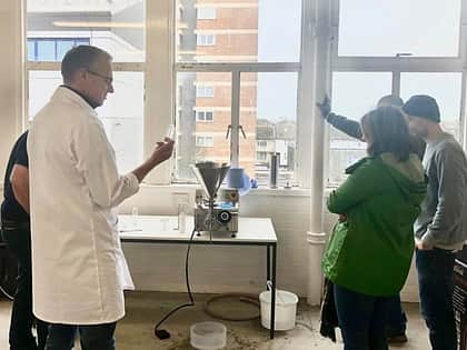 a group of five people gathered around a Reponse Benchtop Filler