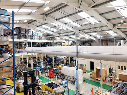 This is a view from the top floor of the warehouse looking out to the machine shop below. Machines are in the middle of being constructed. There are also cold air tubes running through the top of the building.
