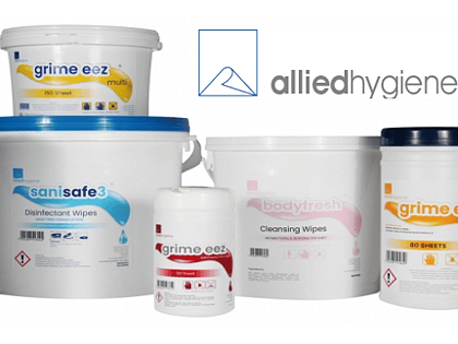 Several white plastic tubs and canisters of hygiene wipes are arranged in a product display beneath the Allied Hygiene logo. Products include disinfectant wipes, cleansing wipes, and multi-purpose cleaning wipes in various container sizes with blue, pink, yellow, and red label accents. The packaging is shown on a white background for a clean, professional product presentation.