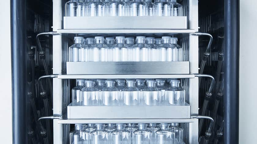 An image of freeze dryer trays holding partially stoppered vials.