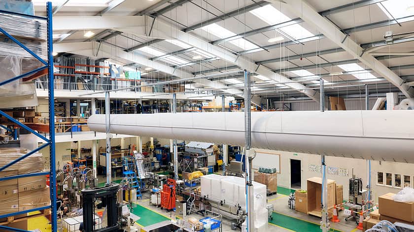 This is a view from the top floor of the warehouse looking out to the machine shop below. Machines are in the middle of being constructed. There are also cold air tubes running through the top of the building.