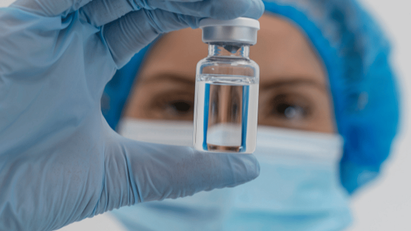 Person Holding Vial Looking Into It 600 x 600