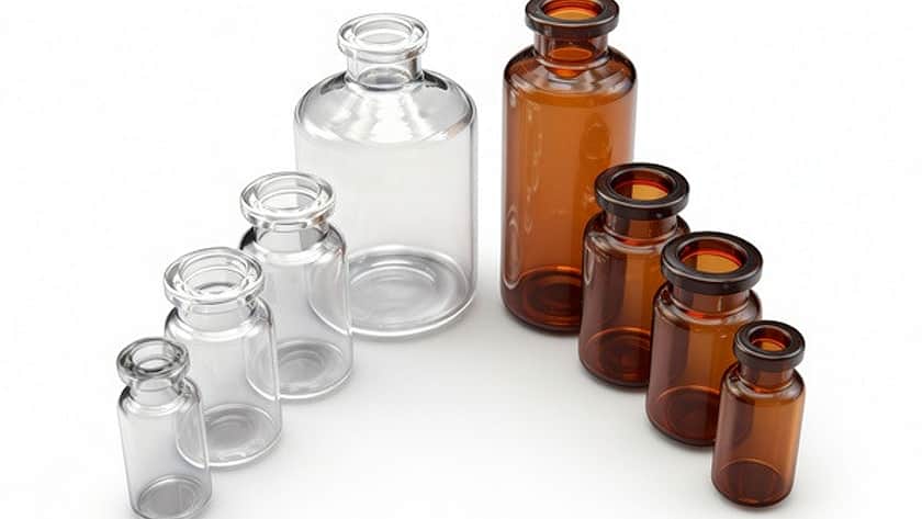 A selection of clear and amber tubular glass injection vials of differing sizes.