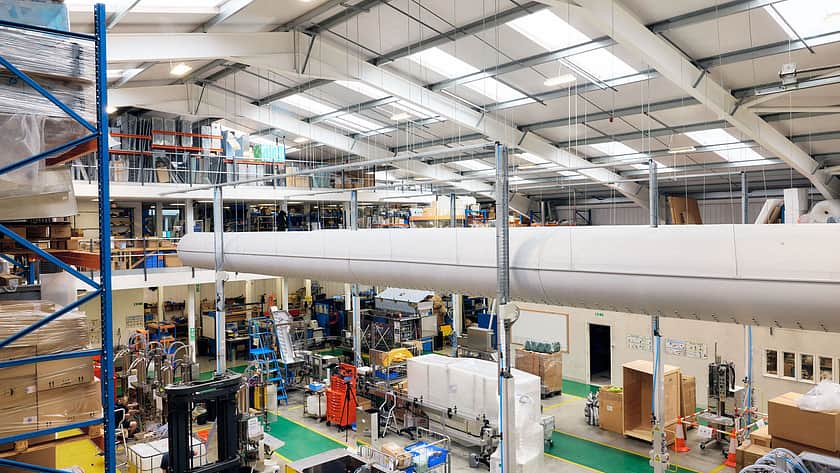 This is a view from the top floor of the warehouse looking out to the machine shop below. Machines are in the middle of being constructed. There are also cold air tubes running through the top of the building.