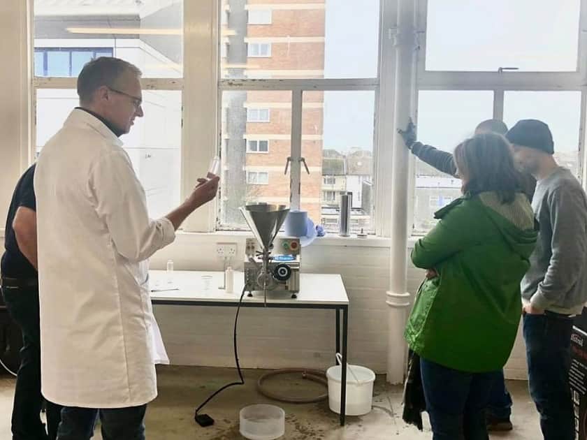 a group of five people gathered around a Reponse Benchtop Filler