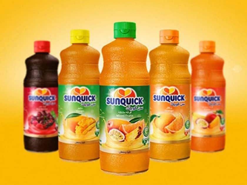 a selection of BIDCORO juice drink bottles on a bright orange background