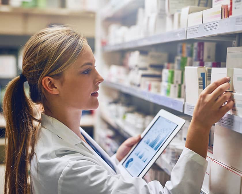 Woman selecting medication from shelf