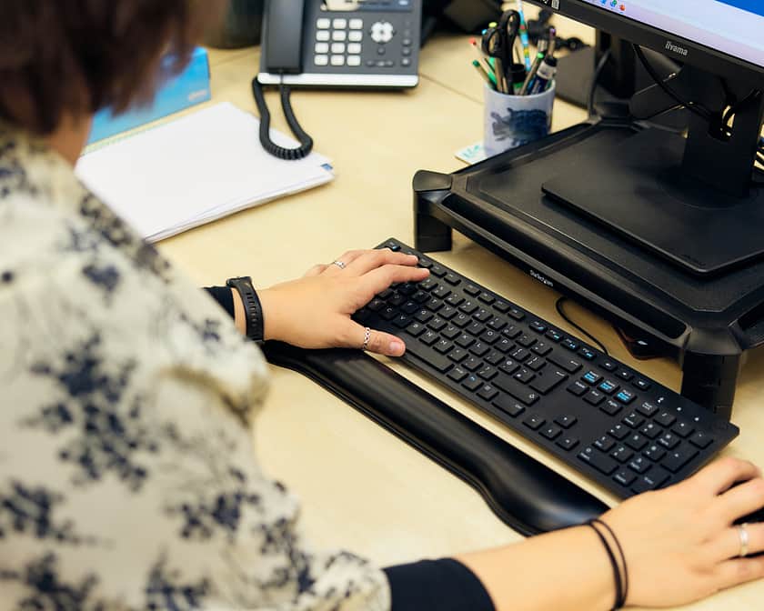 A woman working at a computer.