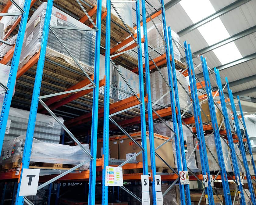 Warehouse racking filled with pallets of stock.