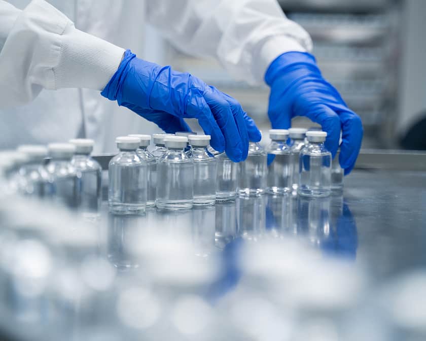 Hands on crimped vials