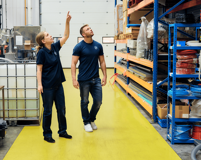 Two People Walking In Shop Floor