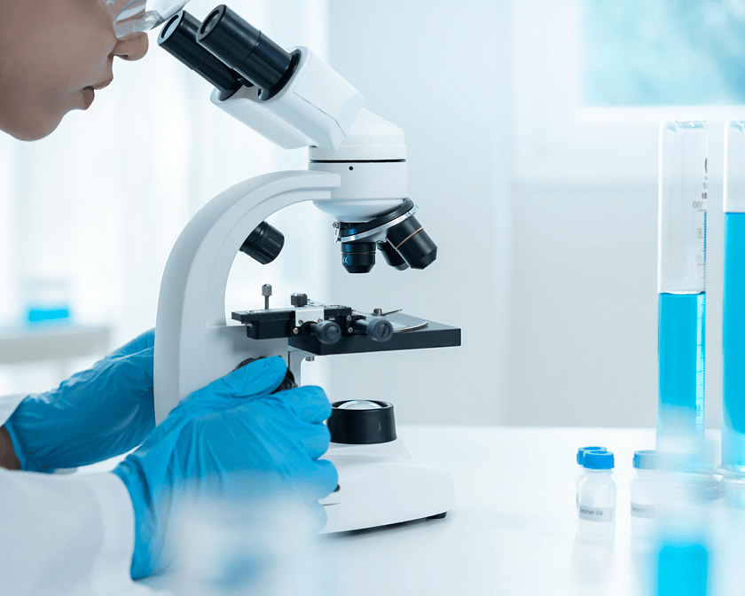 Person looking into a microscope