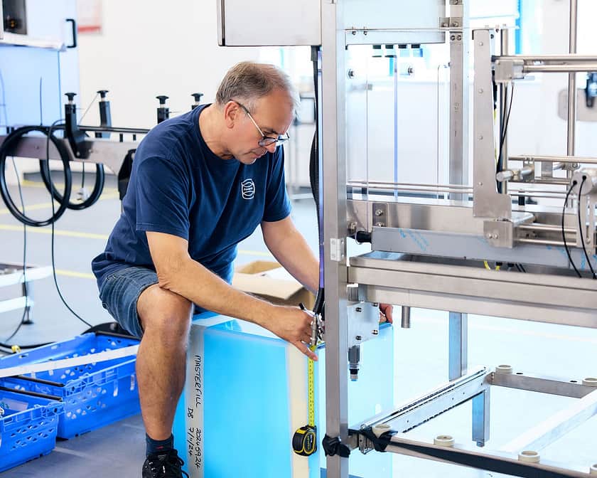 Adelphi 0884 man kneeling on floor building machine