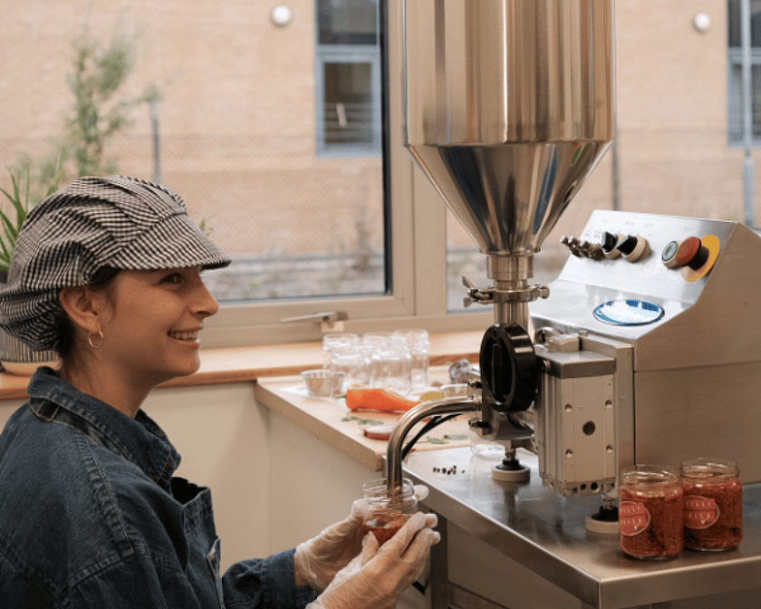 Person Filling Chilli Jam Side On 600 x 600