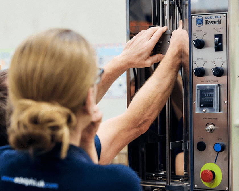 Two People Working On Semi Automatic Volumetric Filling Machine 600 x 600