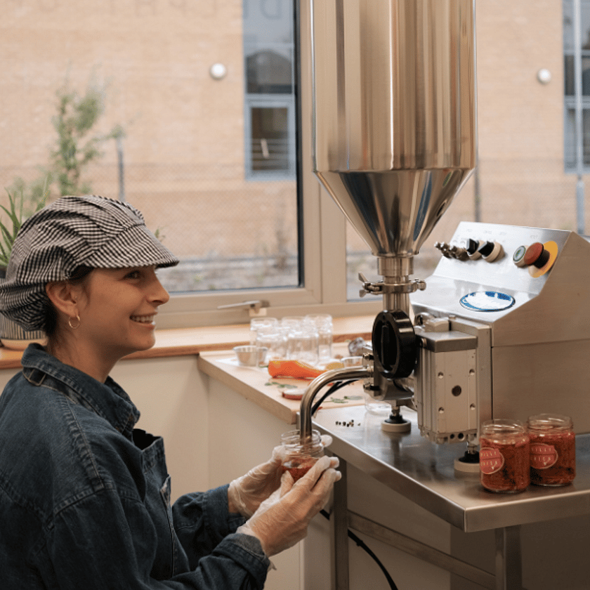 Person Filling Chilli Jam Side On 600x600