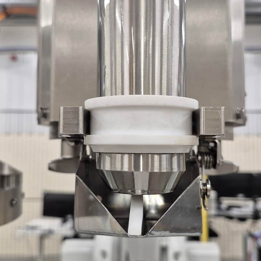 Precision filling nozzle assembly on an automated robotic filling machine designed for accurate bulk liquid dispensing into IBC containers and industrial packaging systems.