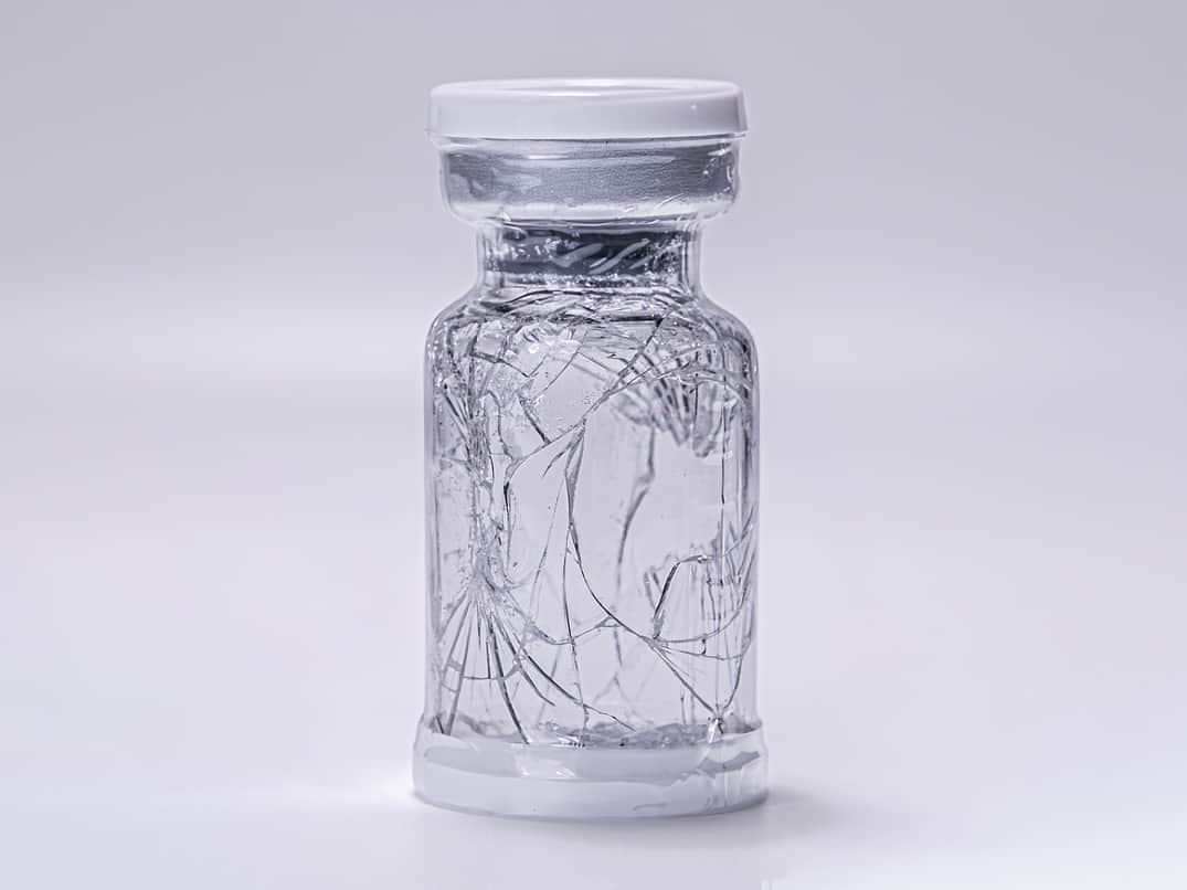 Broken vial in protective sleeve