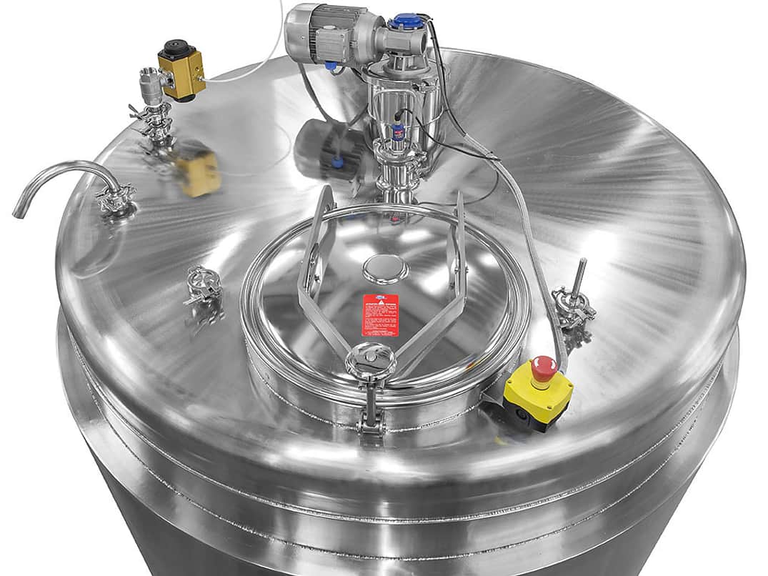 a cropped image of the top of a large silver metal mixing vessel