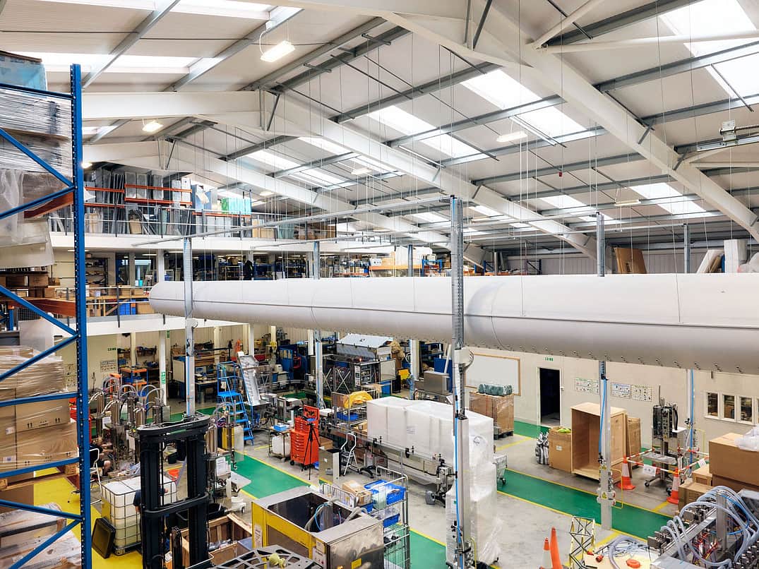 This is a view from the top floor of the warehouse looking out to the machine shop below. Machines are in the middle of being constructed. There are also cold air tubes running through the top of the building.