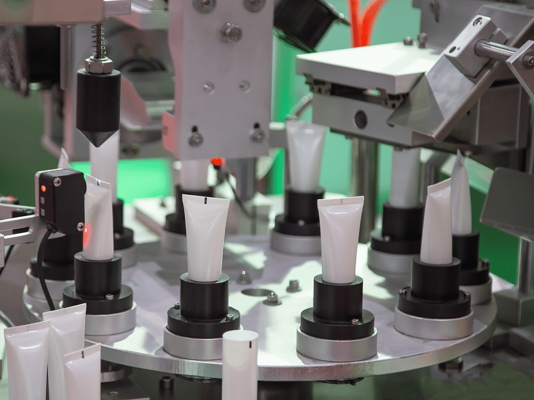 A carousel of tubes ready to be clamped to seal the bottom of the aluminum tube.