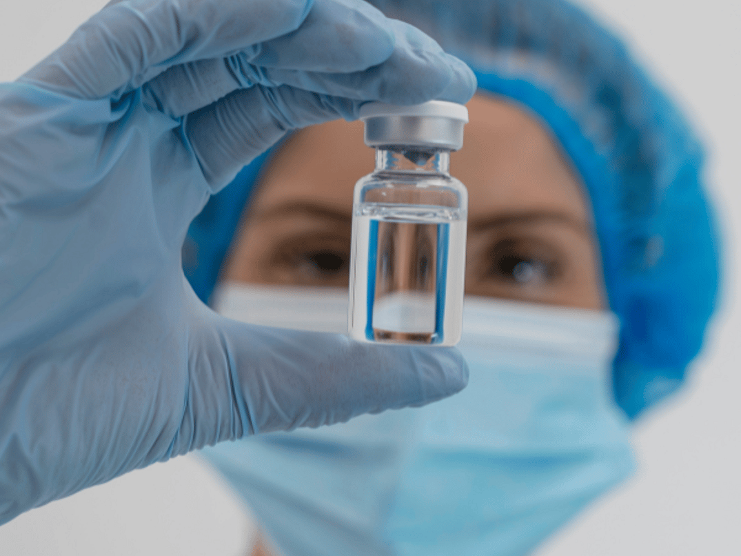 Person Holding Vial Looking Into It 600 x 600