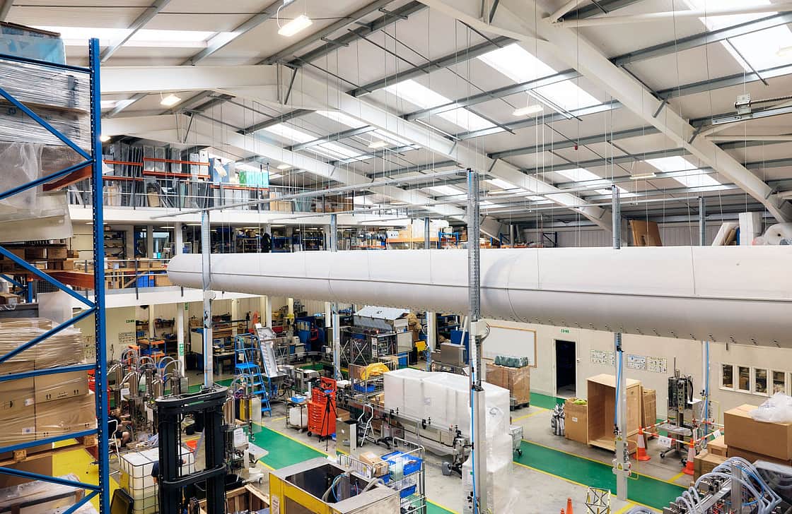 This is a view from the top floor of the warehouse looking out to the machine shop below. Machines are in the middle of being constructed. There are also cold air tubes running through the top of the building.