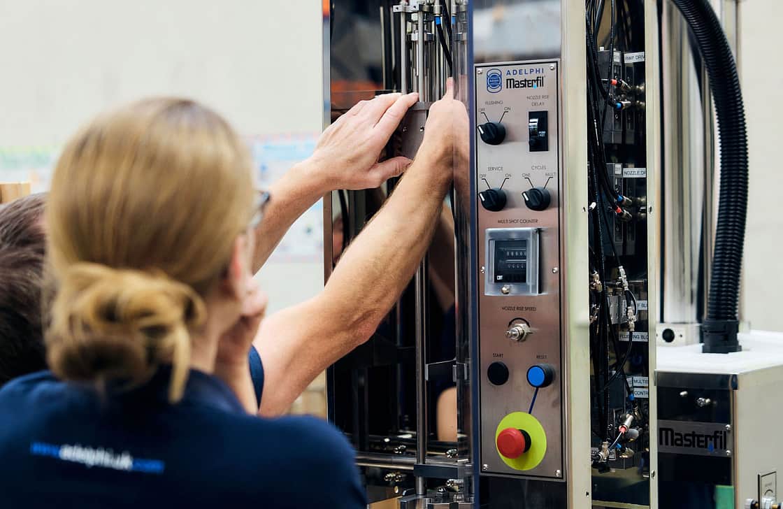 Adelphi 1235 two people fitting machine parts together