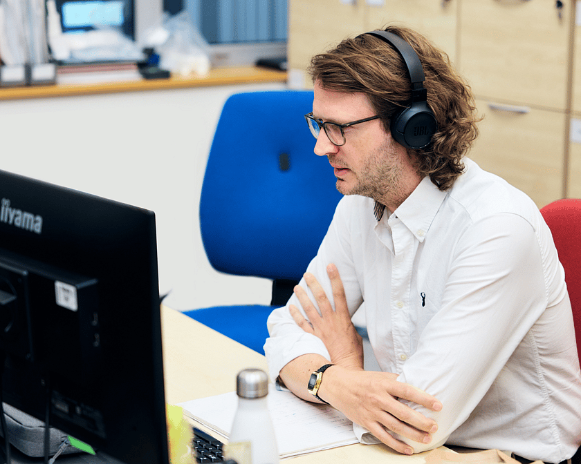 Adelphi 1142 EDITED Person with headphones given support via the screen