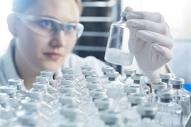 Person holding a vial