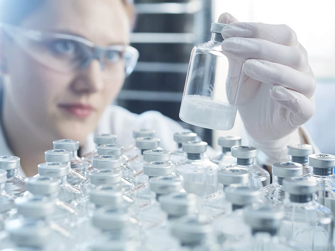 Person holding a vial