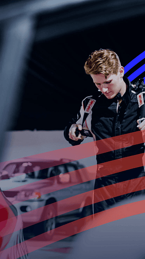 Racing driver adjusts their suit while standing beside cars in a dark garage with graphic overlays.