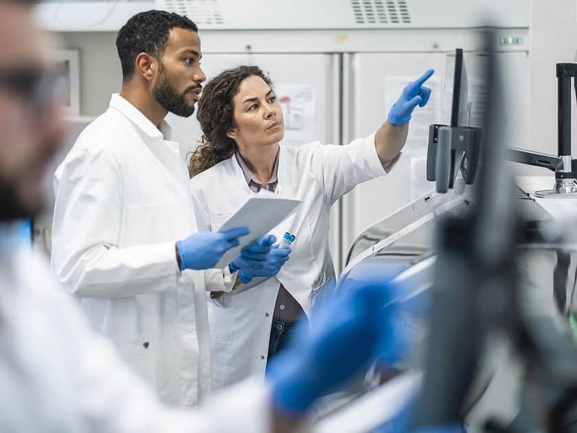 Lab Specialists Pointing at Screen