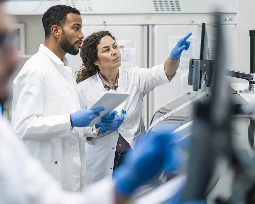 Lab Specialists Pointing at Screen